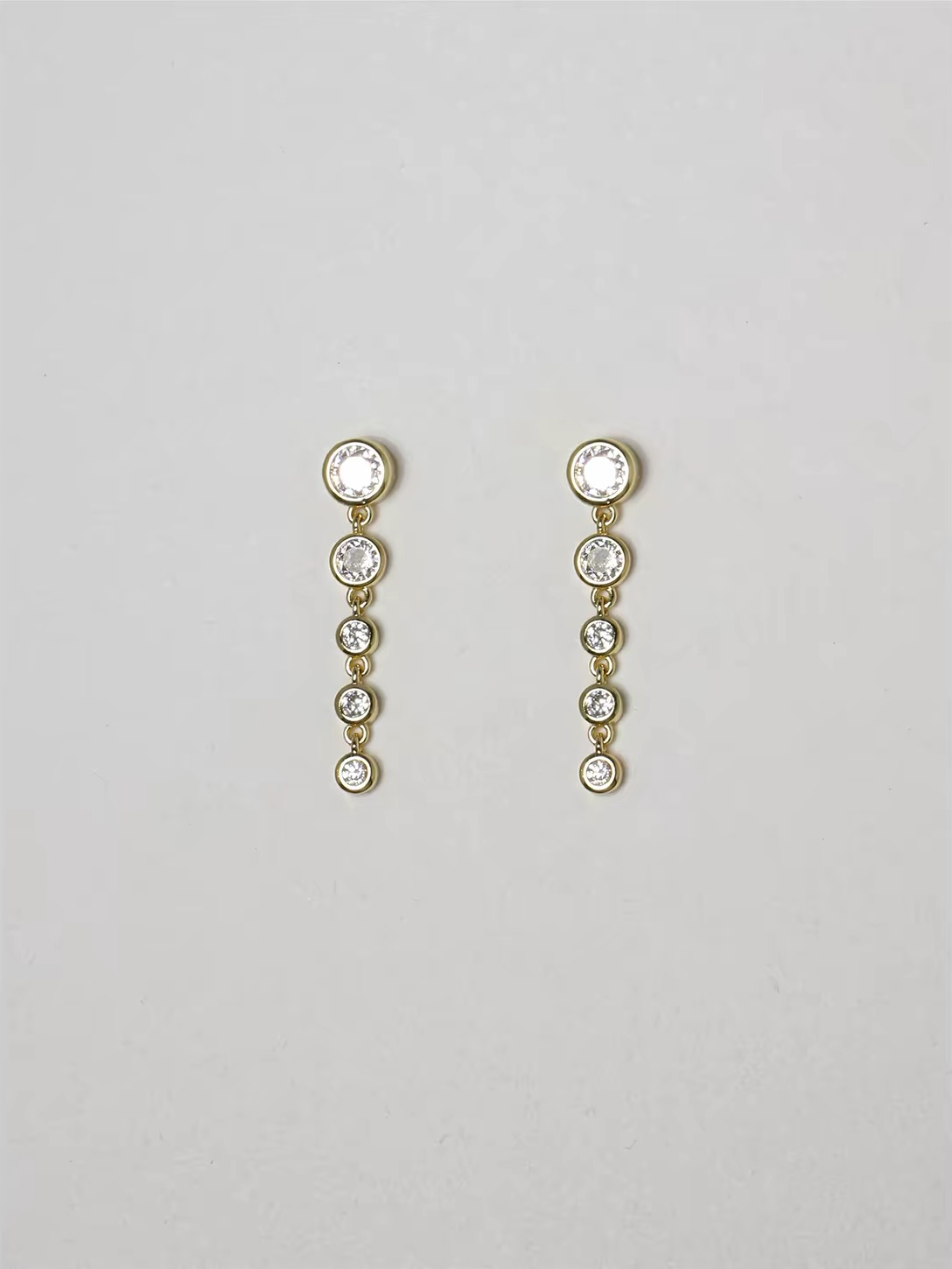 Cascade Earrings in gold with graduated round zirconia drops