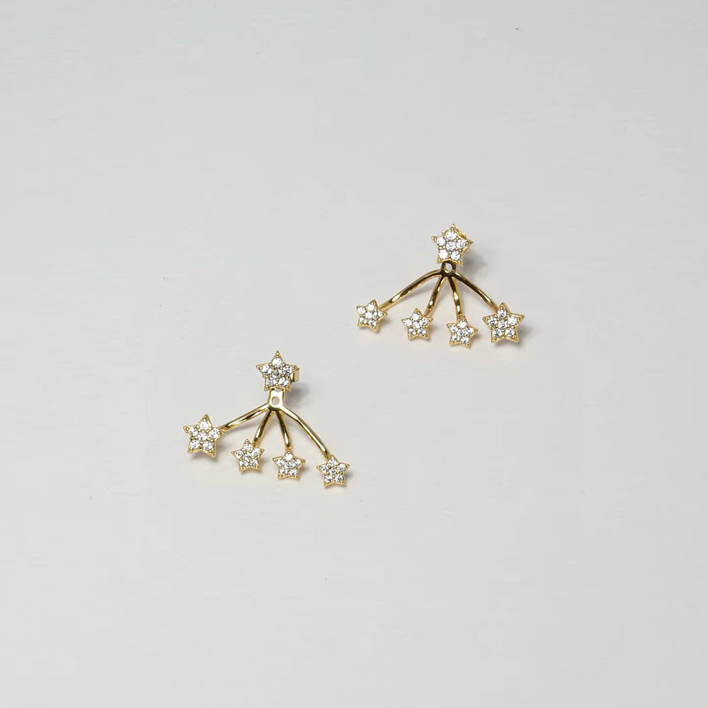 Silver star ear jacket earrings worn in profile
