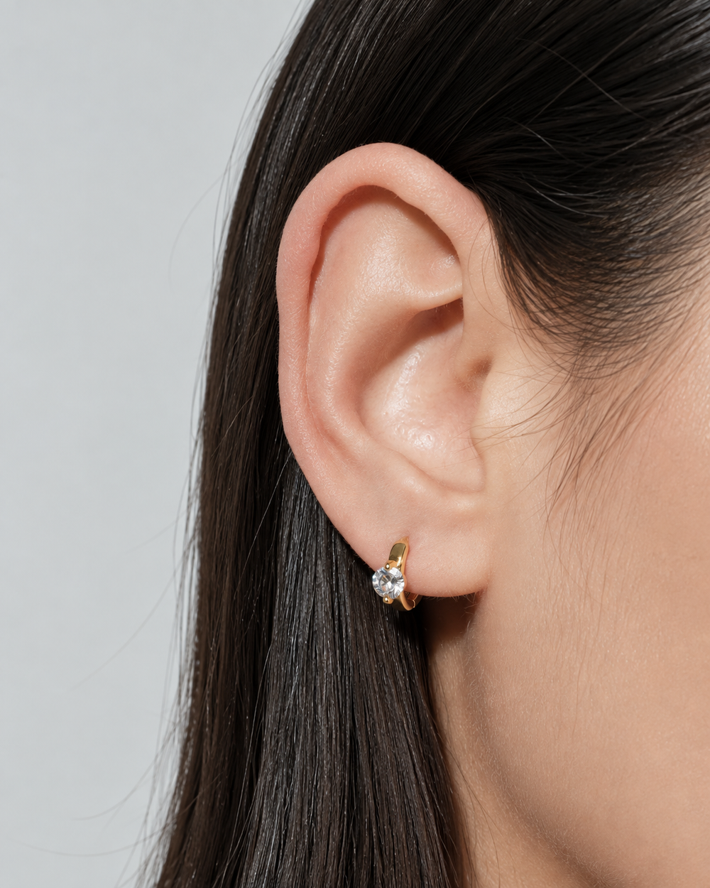 Close-up of a Lumière Mini Hoop worn on the ear