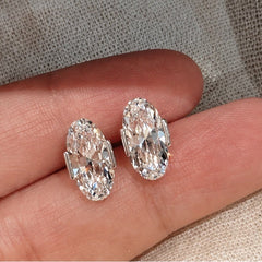 Éclat Ovale earrings shown on hand for scale