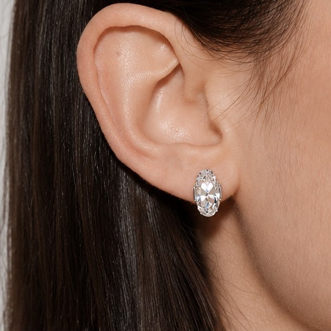 Close-up of Éclat Ovale earring worn on ear