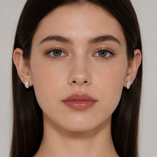 Front portrait of model wearing Éclat Ovale earrings