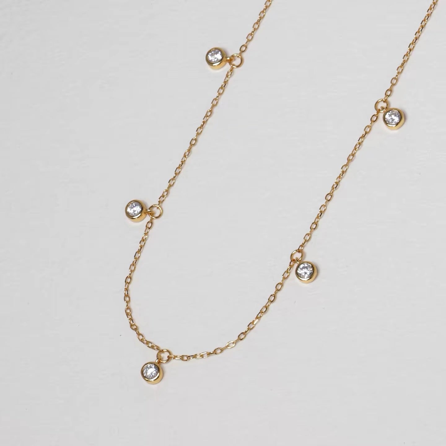 Pluie de Lumière Necklace in gold with five bezel-set zirconia drops
